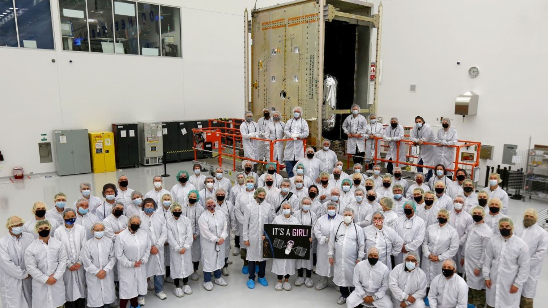 The GPS III government and industry team poses for a photo following core mate completion of GPS III Space Vehicle 10.